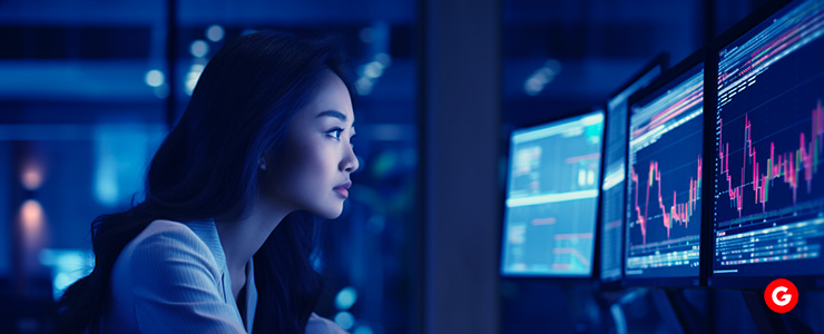 A trader, seated in front of her laptop, emphasizing the importance of portfolio diversification.