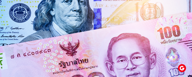 Thai baht and US dollar notes displayed together, showcasing the distinct designs and colors of each currency.
