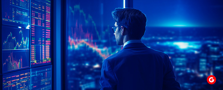 A man in a suit analyzing stock market charts on a digital screen, focused on financial data and trends.